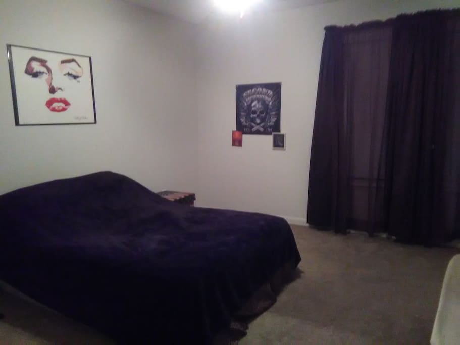 Guests bedroom. Full length mirror, black out curtains, and bed is a double bed.