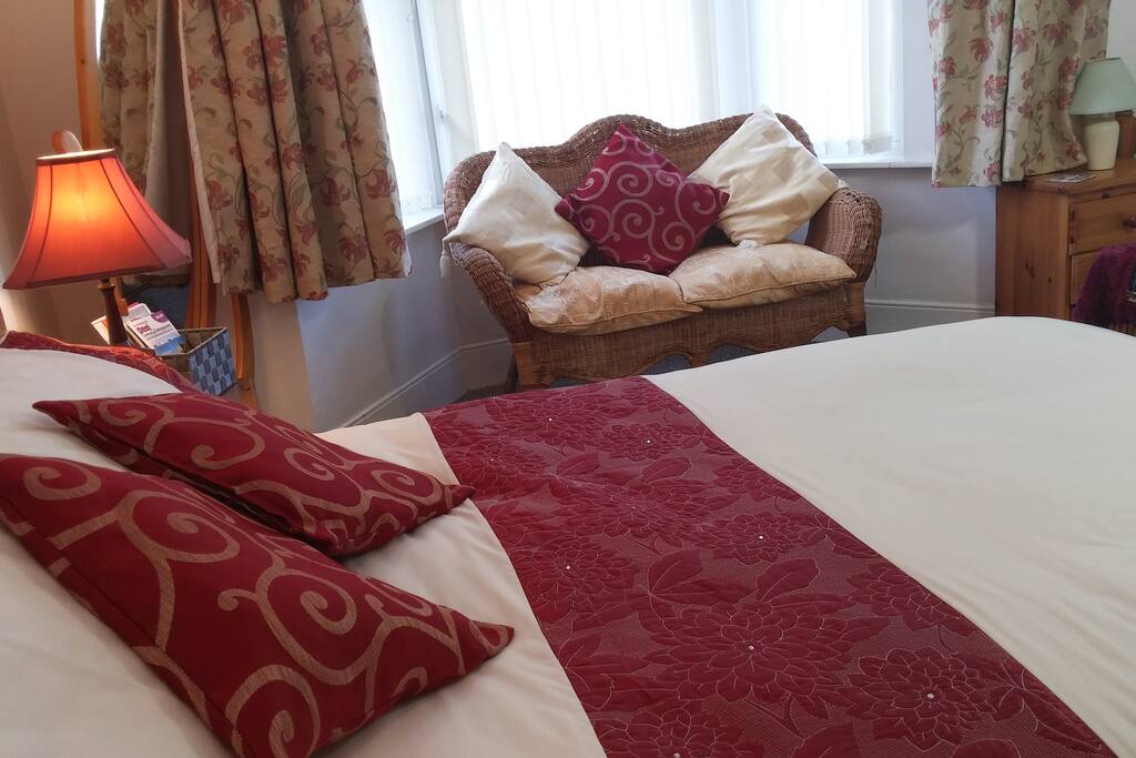It's a very cosy and spacious room with a comfortable double bed and a single bed, chairs & table.