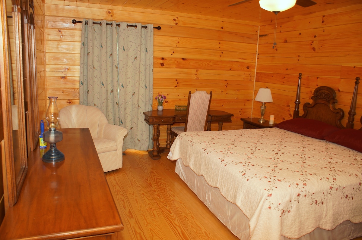 King suite with writing table, wardrobe, dresser, and private bathroom; 1st floor.