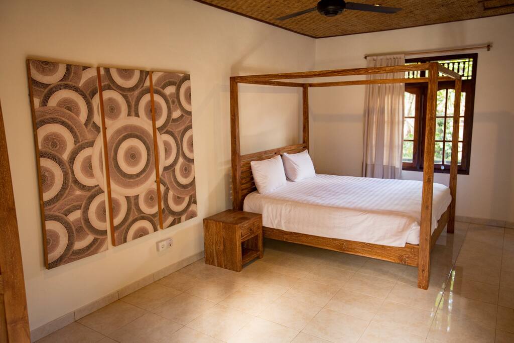 Room 2 with king size bed and it's ceiling fan
