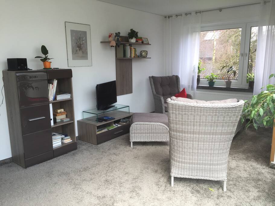 Gemütliches Wohnzimmer mit bodentiefen Fenstern.