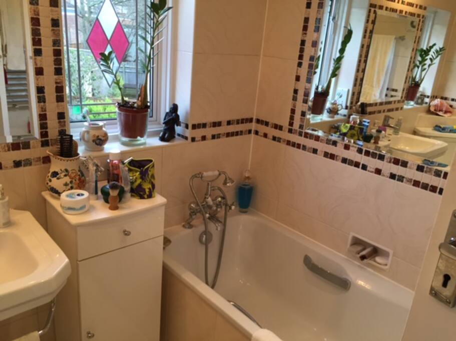 Shared bathroom with bath and shower