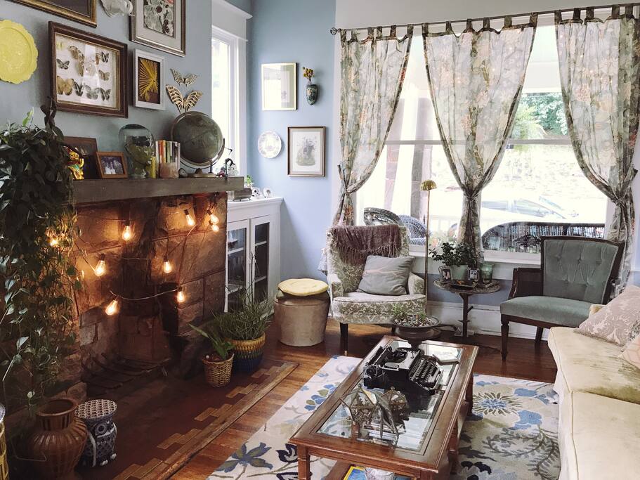 Living room is full of art and vintage furniture.