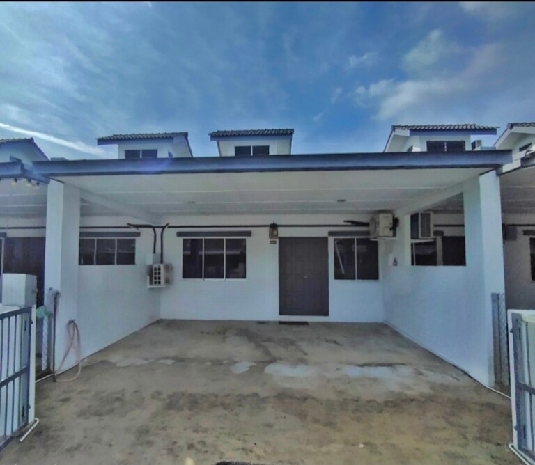 A spacious exterior area is featured, with a concrete surface and multiple windows allowing natural light. The entrance is marked by a solid door, and air conditioning units are visible on the side walls. The sky is partly cloudy, providing a bright ambiance.