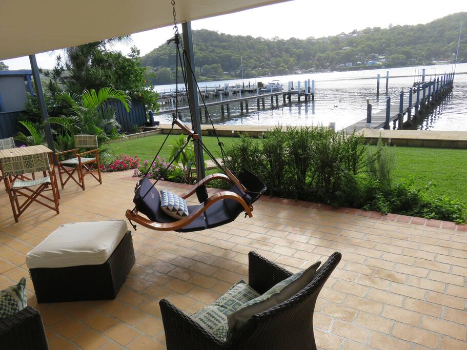 Terrace with sofa & foot rest. Hanging chair has a sling to put your feet up (very laid back), & a hanging cup holder.