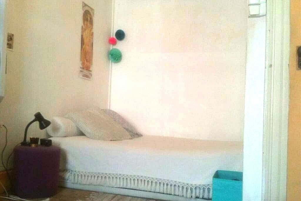 Le lit est situé dans une alcôve au fond de la chambre.