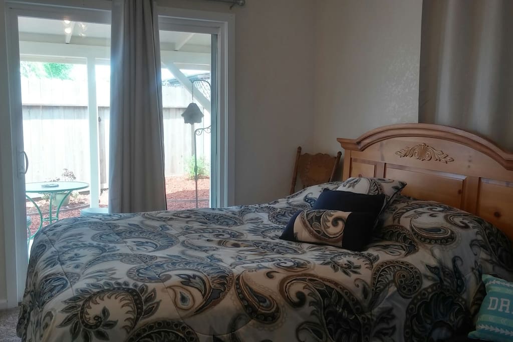 Queen size bed and slider door to back patio.