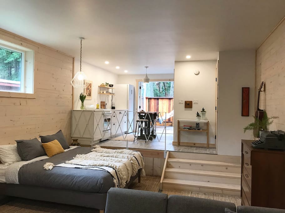 Loft Style Studio with overheight ceilings, concrete floors and pine board walls.
