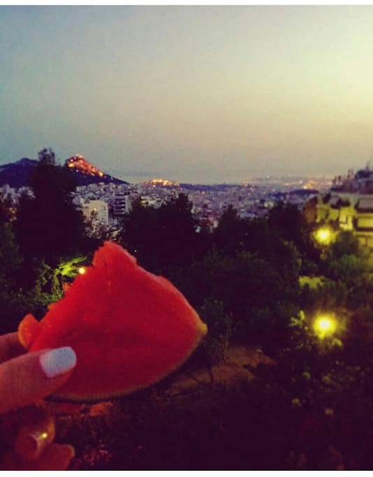 Balcony view -Lycabettus, Acropolis and the sea- at dusk