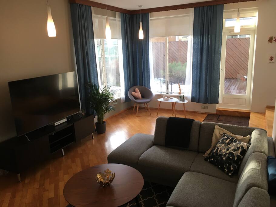 Living room, tv with Netflix, access to patio visible
