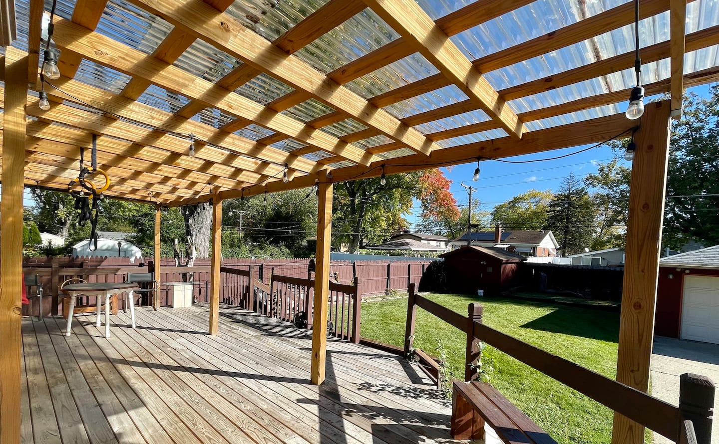 The outdoor patio with a seating area and grill, ideal for enjoying sunny afternoons.