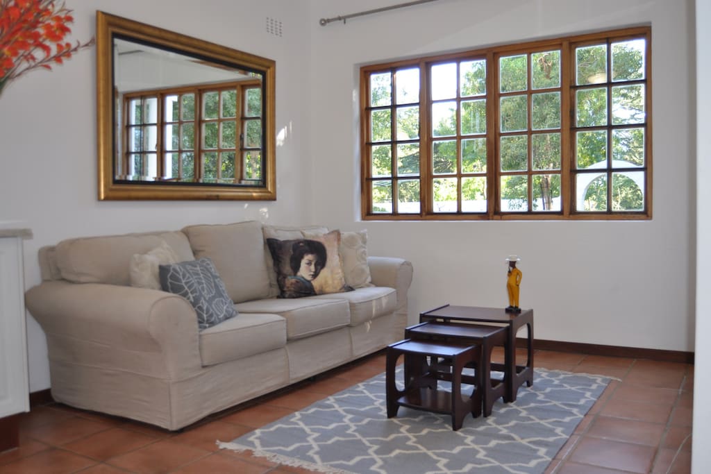 Extra long comfy linen couch. Looks out onto your own private garden.
