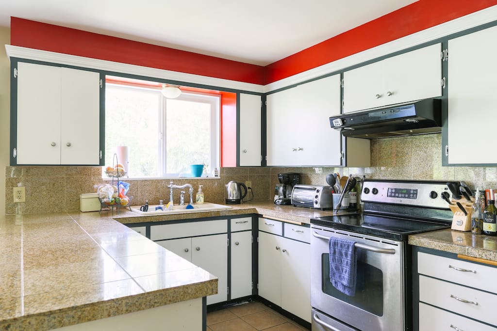 Fully stocked kitchen with appliances, cookware and dishwasher