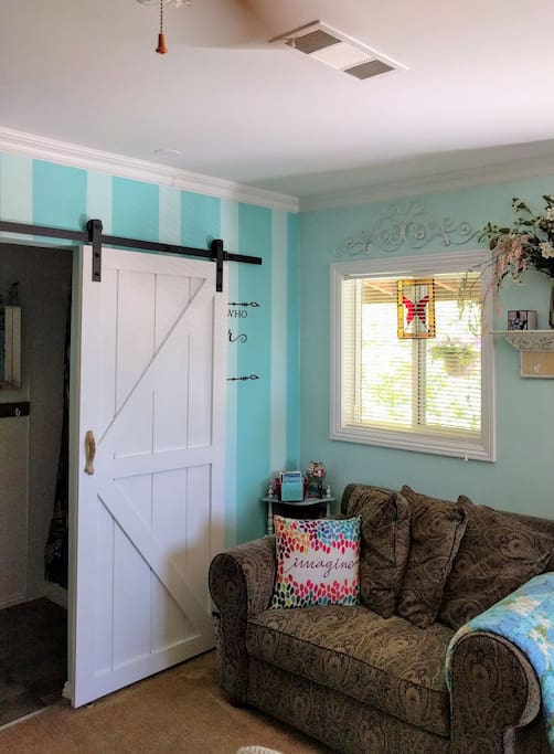small loveseat, that makes into twin bed. also sliding door to bathroom.