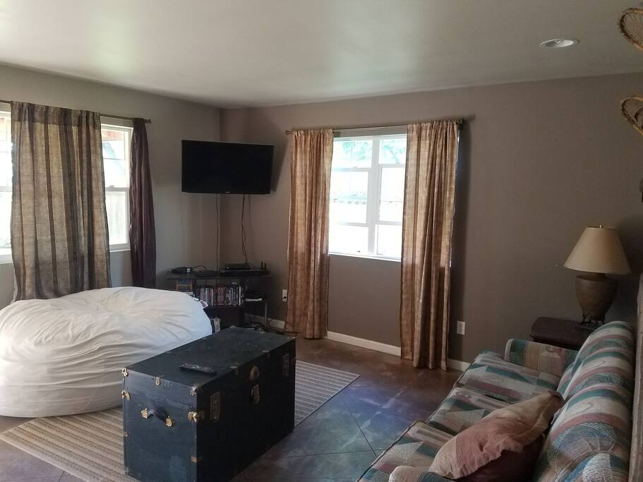 Living area, 42 inch tv, trunk storage, giant foof bean bag, couch is a sleeper sofa.