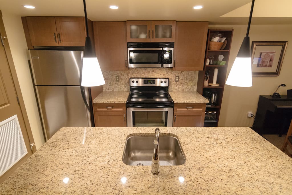 Fully equipped kitchen with new appliances and quartz counters.