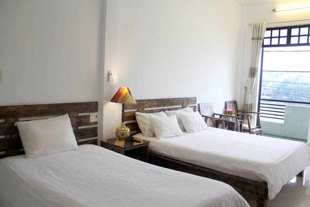 This nice and clean room is located on the 1st floor. It has a private balcony with beautiful views of lovely Nhu Y river and famous Perfume River. The room consists of nice twin beds (1.2m and 1.6m) and facilities like a 2-star hotel. The private bathroom, coffee table with 2 chairs, hair dryer, wifi, TV... and shared kitchen will make you feel comfortable during your short or long stay with us. It's highly recommended for a small family of 3-4 persons or couple to stay with us in this room