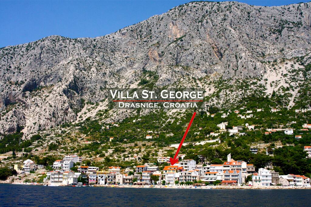 The small village of Drašnice on the Adriatic sea with Mt. Biokovo rising behind it
