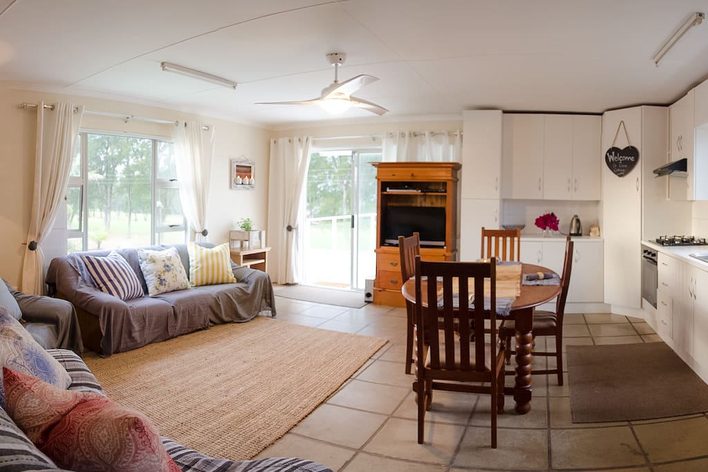 Bright & Airy open plan lounge, dining area & full kitchen along with panoramic views of the Gonubie Golf Course (top floor).