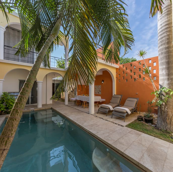 Luxurious pool area with loungers and outdoor dining