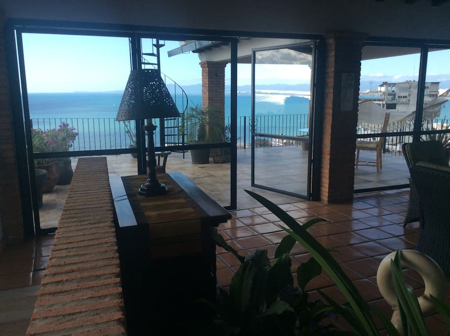 View of deck from living room through dining room. Access staircase is on the left
