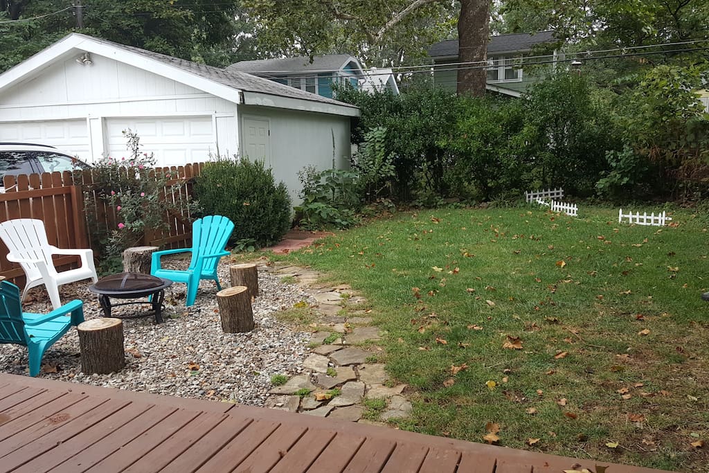Relaxing fenced in backyard with firepit
