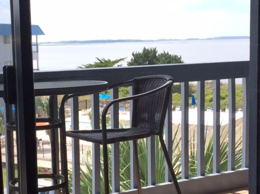 Lovely view of the big ships & dolphins playing; 3rd floor balcony w/tall table & chairs