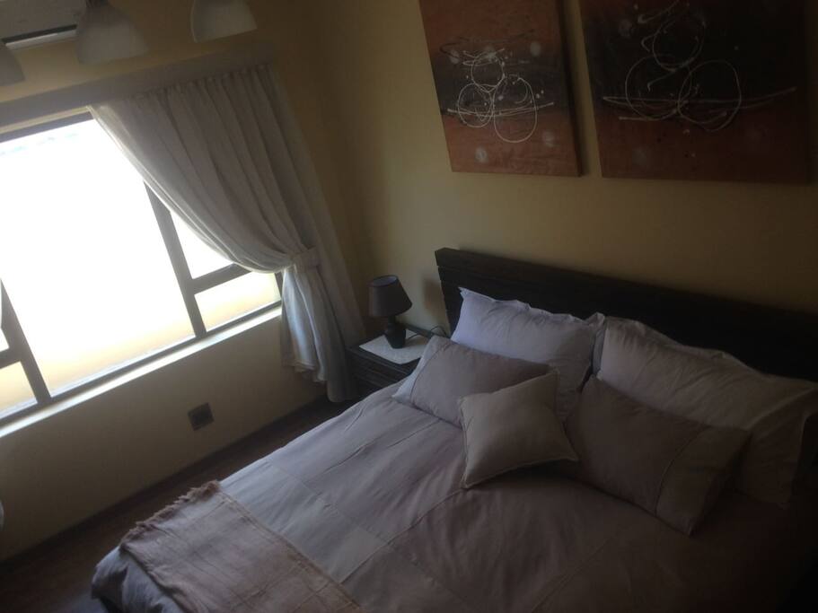Queen size bed room equiped with dual air conditioning and tv
