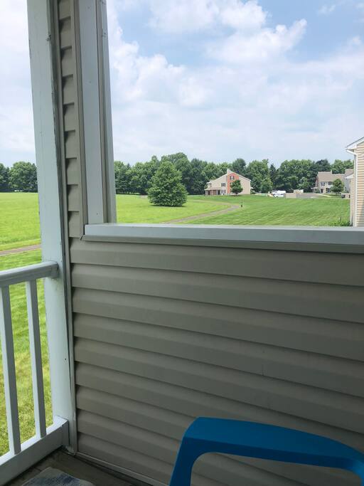 Patio overlooking open space and walking trail - two chairs and coffee table on patio.
