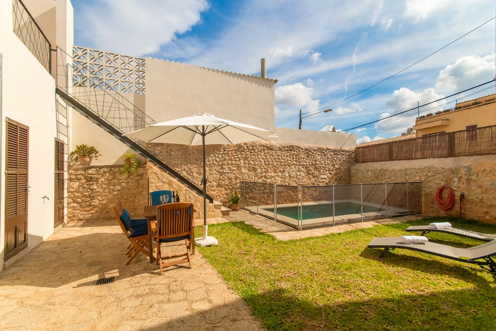 Terrace with garden pool and sun beds