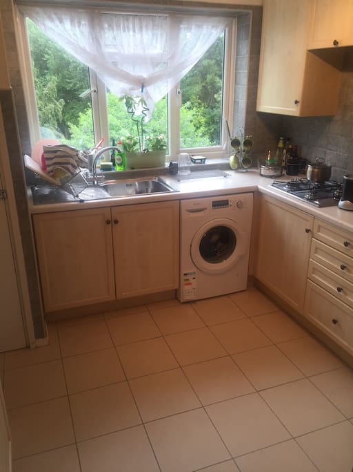 Kitchen with Washing machine, fridge, micro wave and all other crockery, cutlery and required utensils