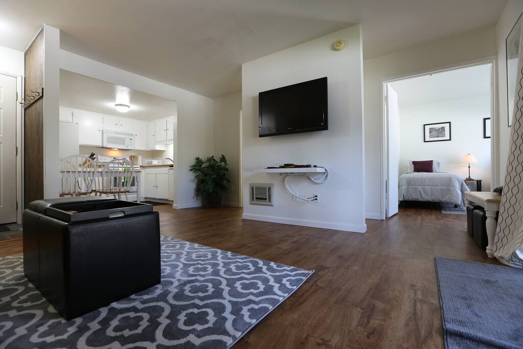 Living room flows into light, bright kitchen with modern appliances