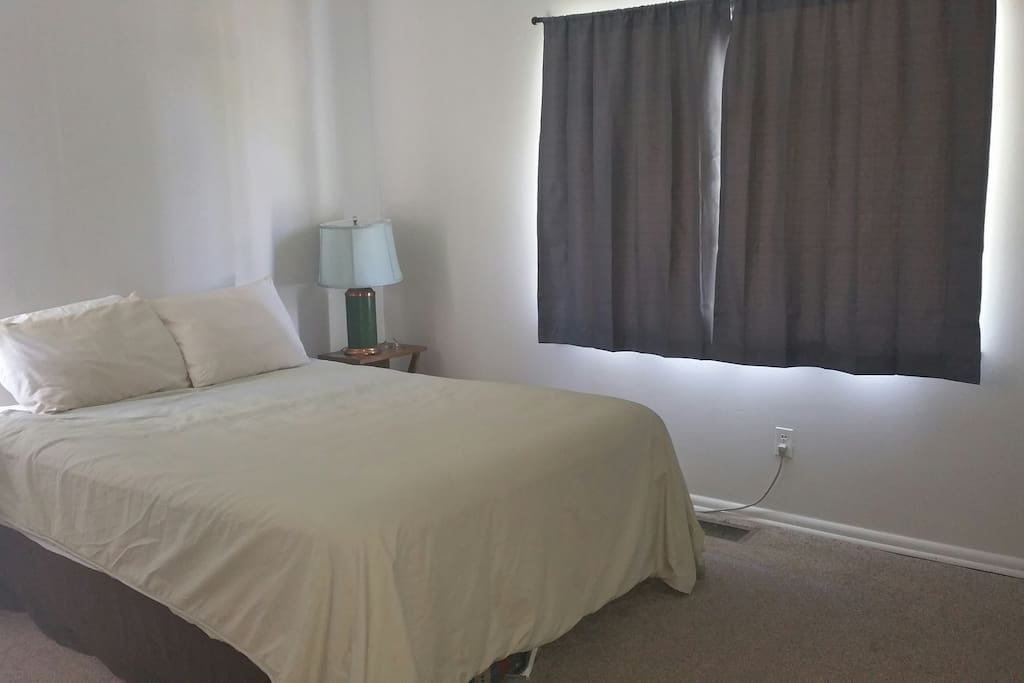 Queen bed in spacious bedroom with closet and dresser