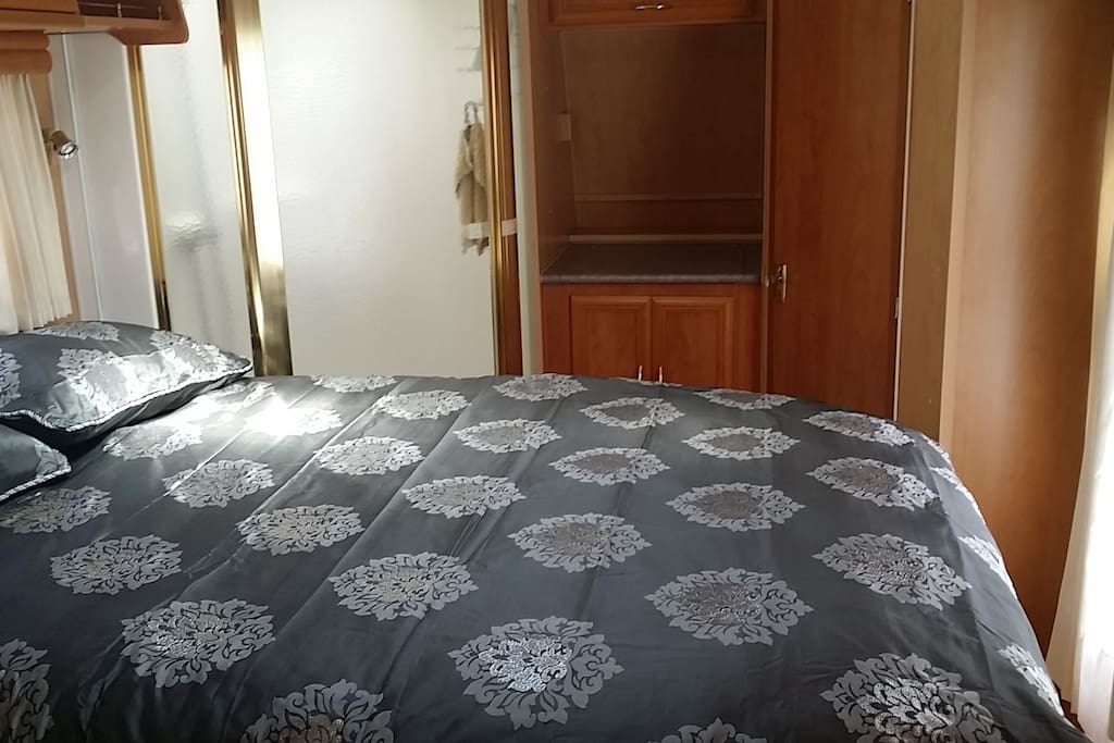 Room with lots of storage space, wardrobe, mirror and window. Stateroom en-suite shower available on commercial site.