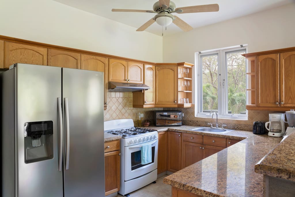Full kitchen with stainless appliances, coffee maker, blender, microwave.