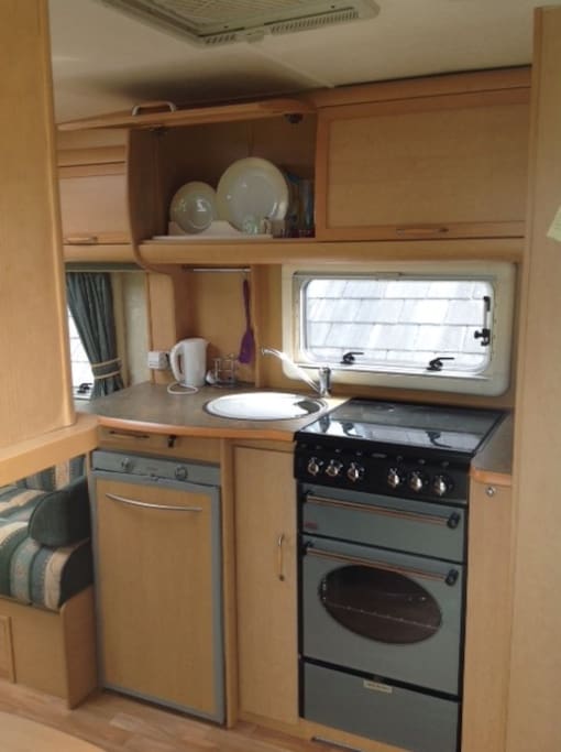 Kitchen area with gas cooker, sink and good sized fridge