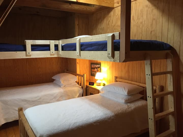 Upstairs bunk room has a lake view and four twin beds.