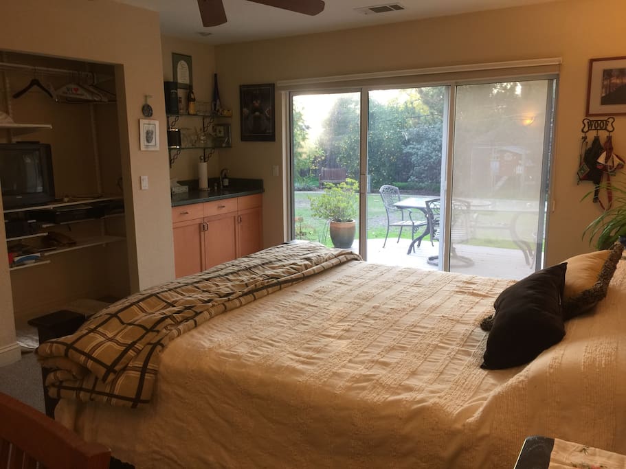 The view from the desk toward the wet bar on the left, closet and TV and sliding door onto your own deck!