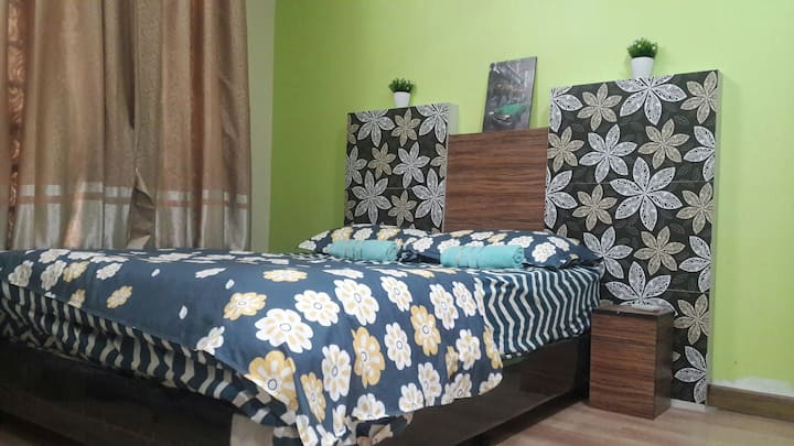 master bedroom with attached toilet inside equipped with air conditioner,wardrobe and ceiling fan