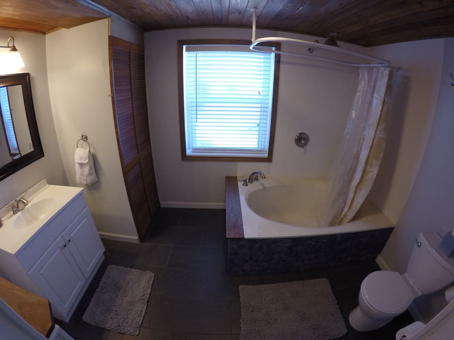 Large bath tub with rain-shower.