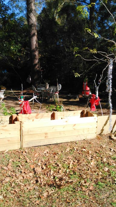 Outdoor natural DIY Christmas theme. New planters house baby bamboo which soon will eventually serve as privacy fencing.