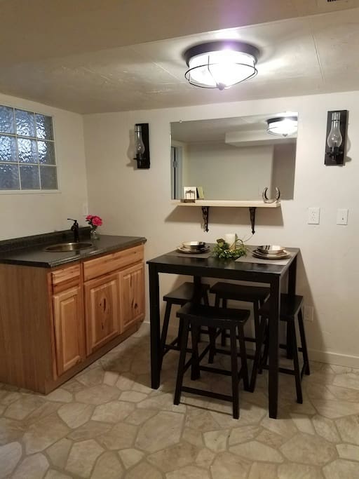 Kitchen with stove, microwave and refrigerator. Washer and dryer are available in the room adjacent to the kitchen.