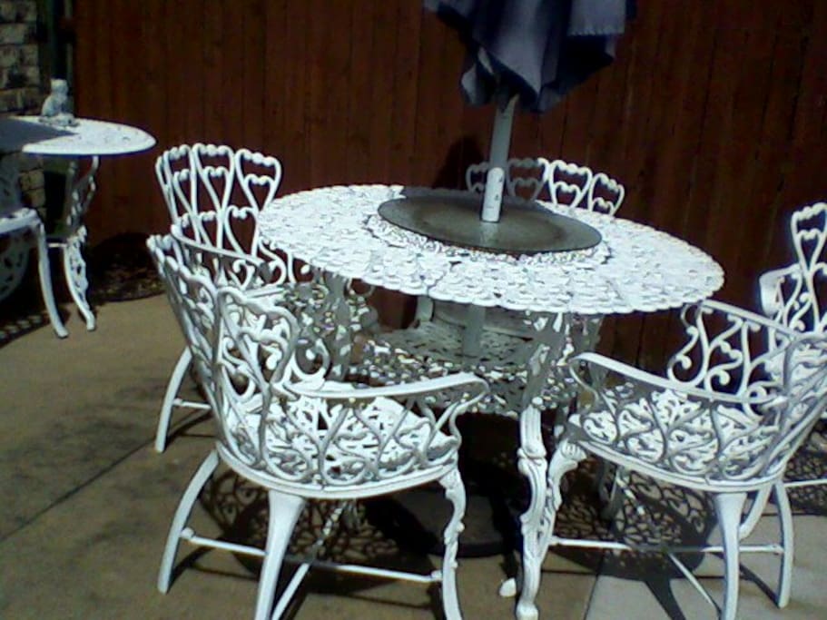 Patio furniture inside a 6 ft. wooden fence backyard.