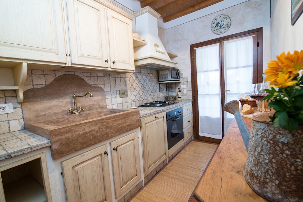 Kitchen (with fridge, oven, fires, microwave) open on the patio