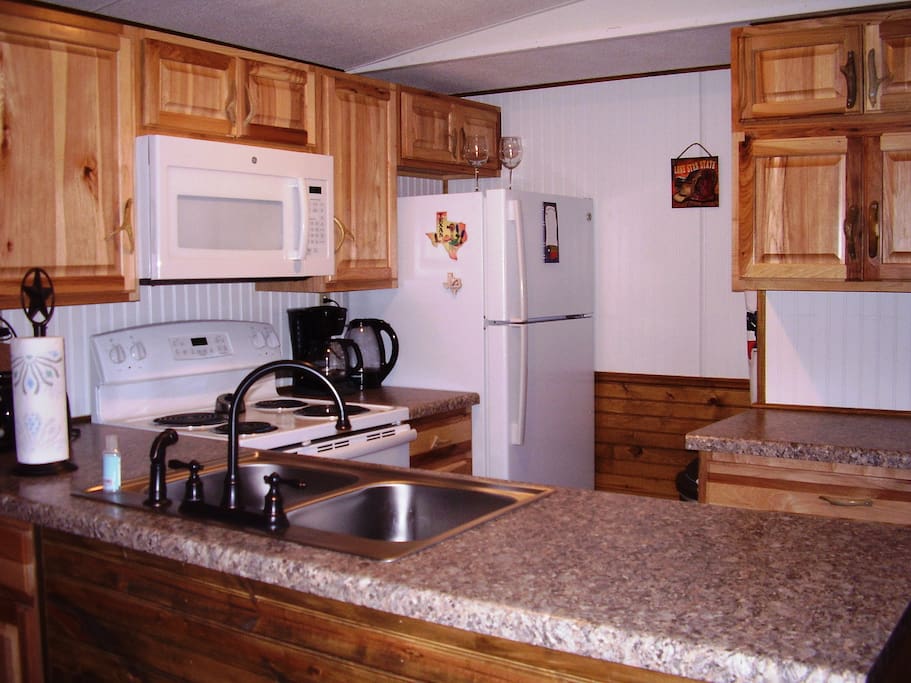 Completely renovated kitchen with 2015 appliances, Texas pine cabinetry with antler hardware. Includes dishwasher.