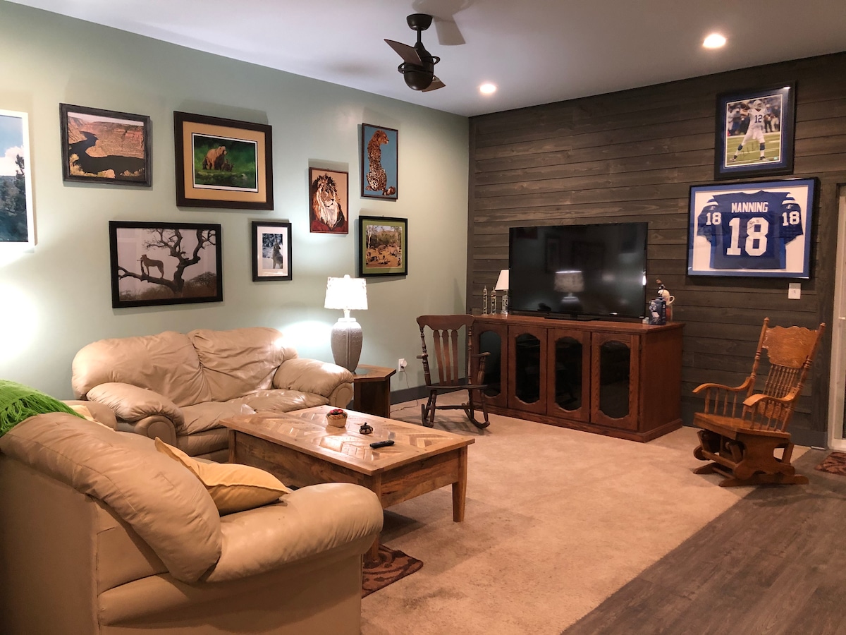 Common TV area has queen bed in couch and is open to the kitchen