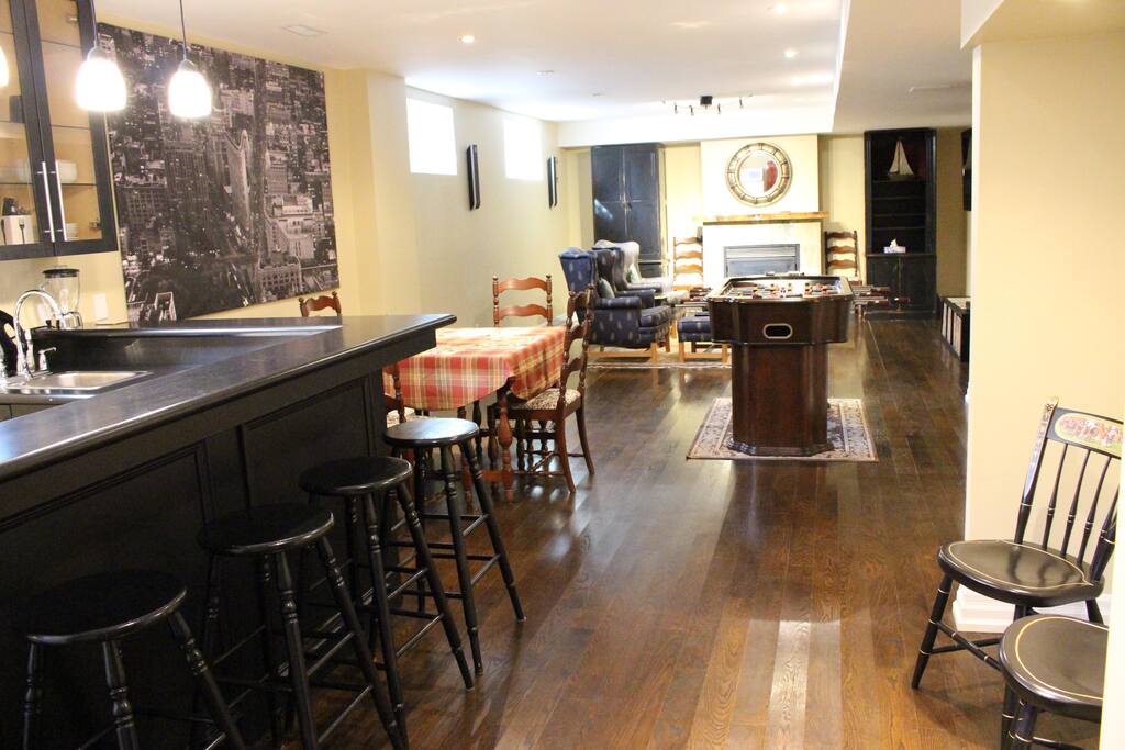 Hardwood floors and large basement windows overlook the living room and games room combo. A gas fireplace is a popular amenity. The hot-tub in the back yard is available to guests for bookings of 2+ nights