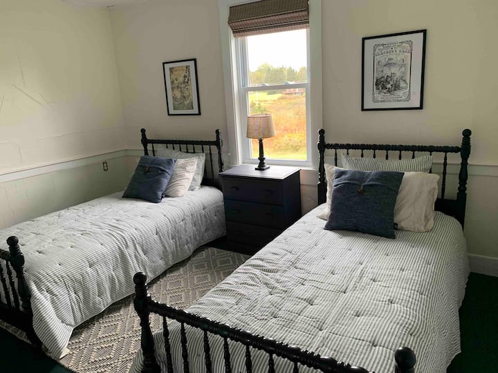 The twin bedroom also has new mattresses with all new, natural bedding. Cotton sheets, new pillows, and antique bedframes. 