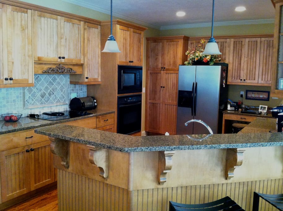 Kitchen with entrance from 3 car garage and access to laundry room-opens to breakfast area