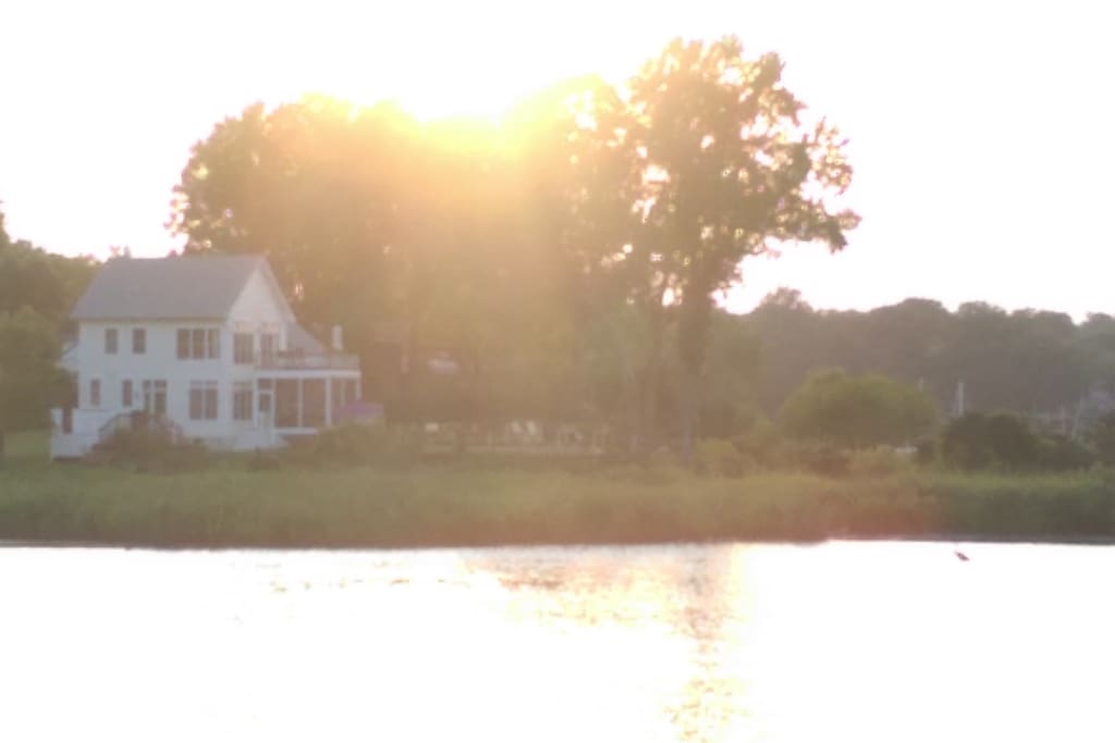 The house as seen from across the water. We are on a river and a lake.